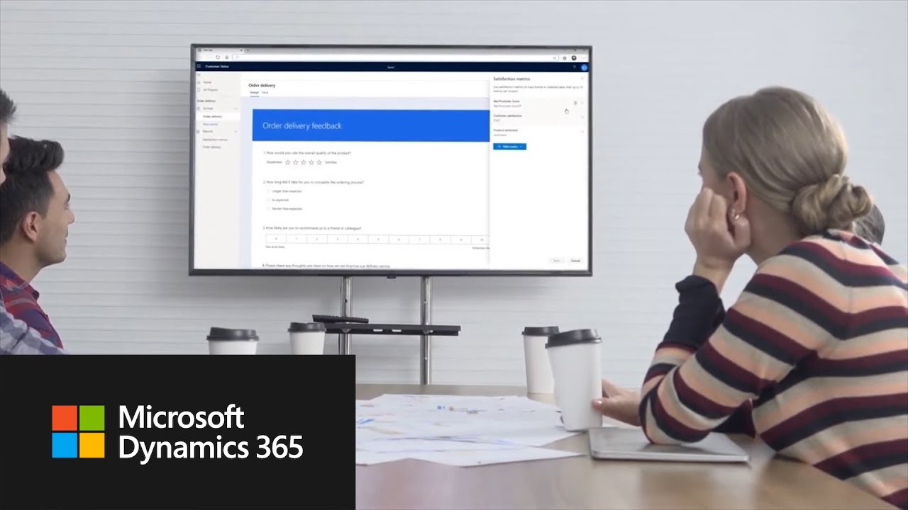 Team viewing Dynamics 365 Customer Voice interface on a large screen with a feedback form displayed