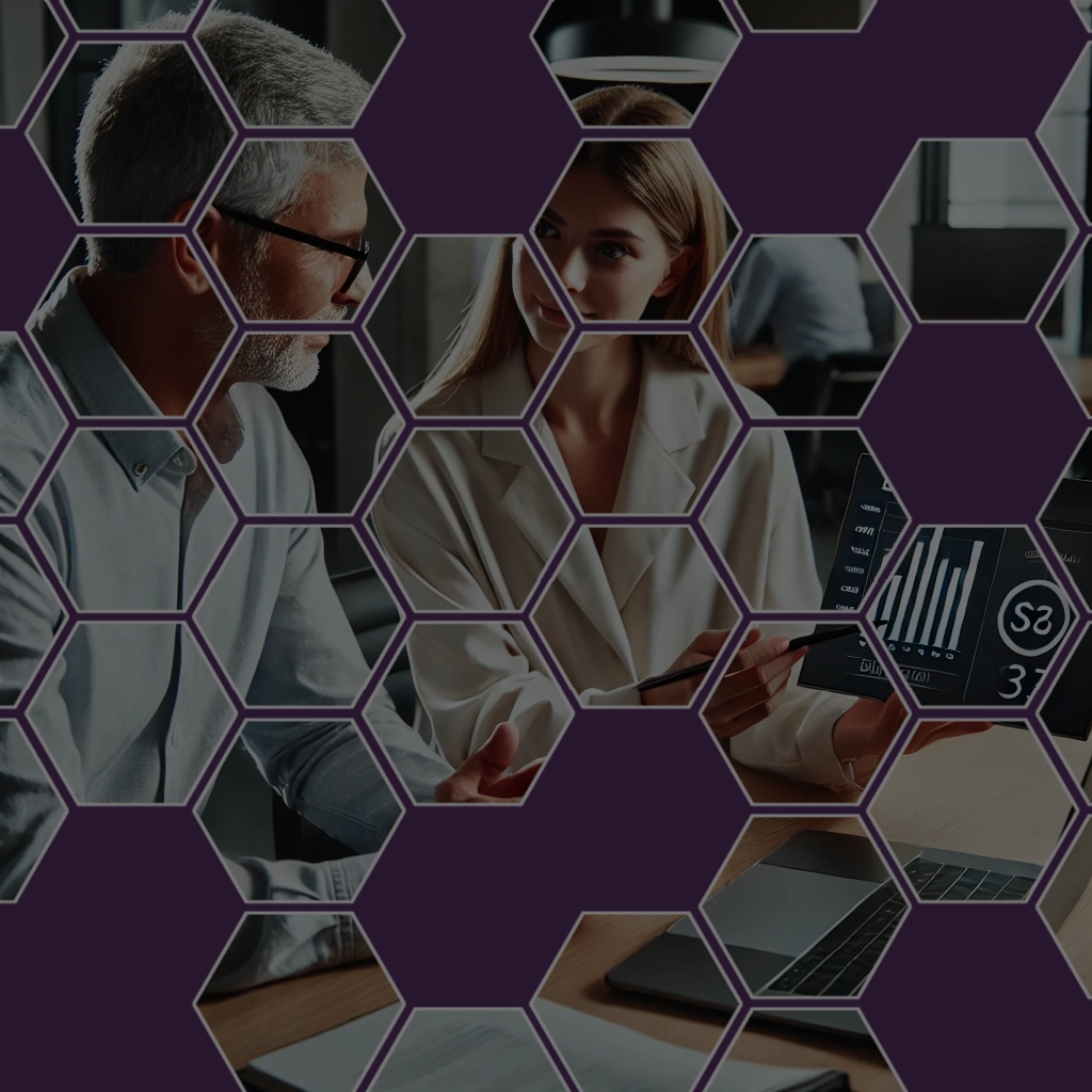 A professional man and woman discussing data on a tablet, overlaid with a honeycomb-shaped design, blending creativity and business innovation.